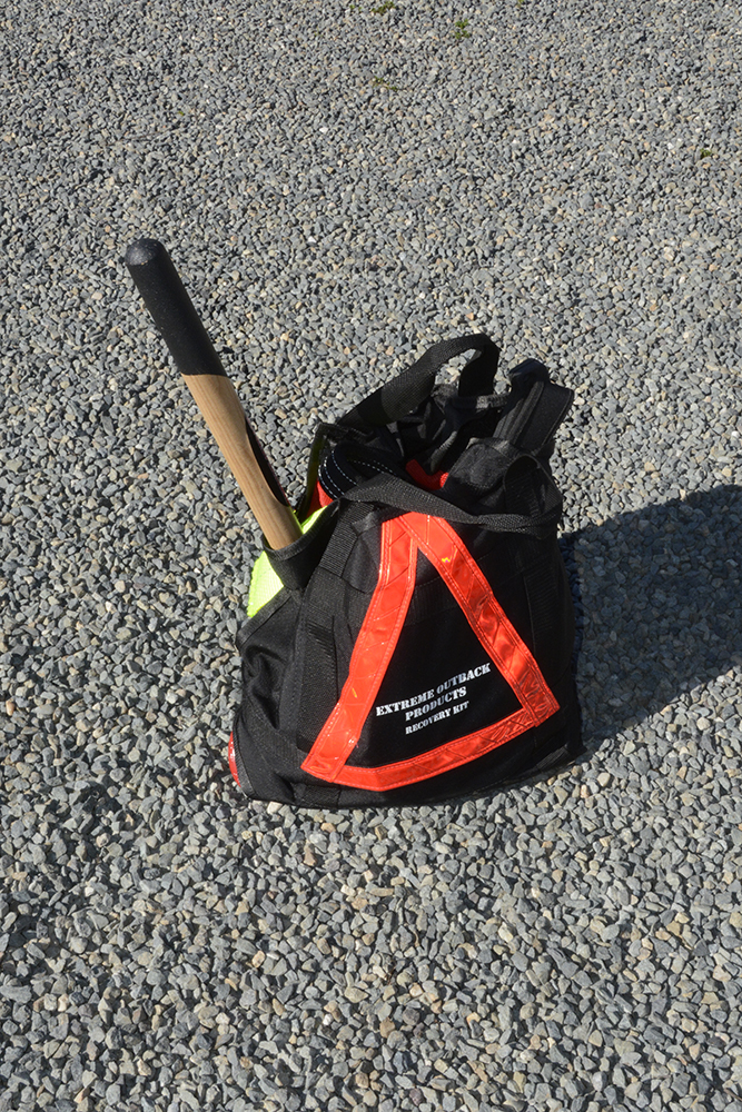 This recovery bag by Extreme Outback Products comes with practically everything you need for recovery situations, including a small shovel.